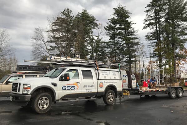 GBS utility truck with service equipment parked in lot near trees
