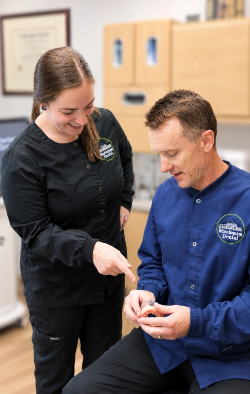 Winnisquam Dental staff examining a mouthguard together